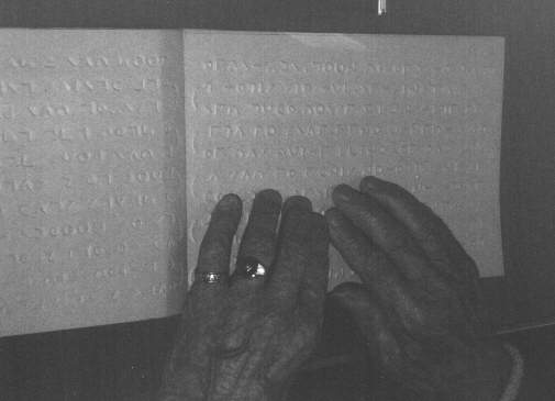 This is where their is a image of a person reading moon, the moon book  is laid out in front of the person and he/she is reading it with their fingers as we do with our Braille books and magazines, this is how it has been described to me I hope that you will forgive me for this explanation
